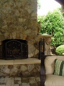 stone vaneer wood bruning fireplace with sandstone hearth and shoulders