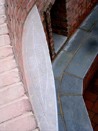 hand carved leaf in top of bluestone mantle