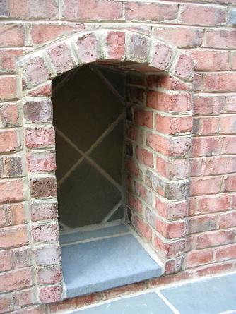 built-in wood or fire-tool storage
