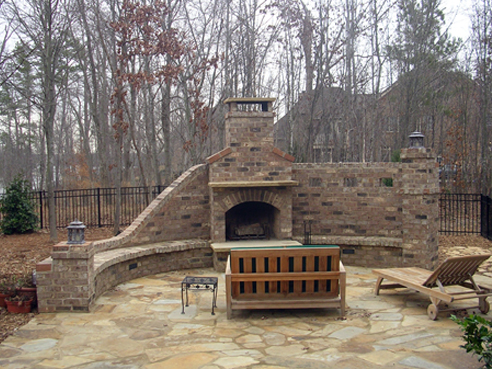 brick fireplace with stone patio