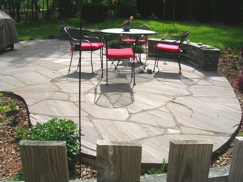 irregular bluestone patio with stacked stone sitting benches